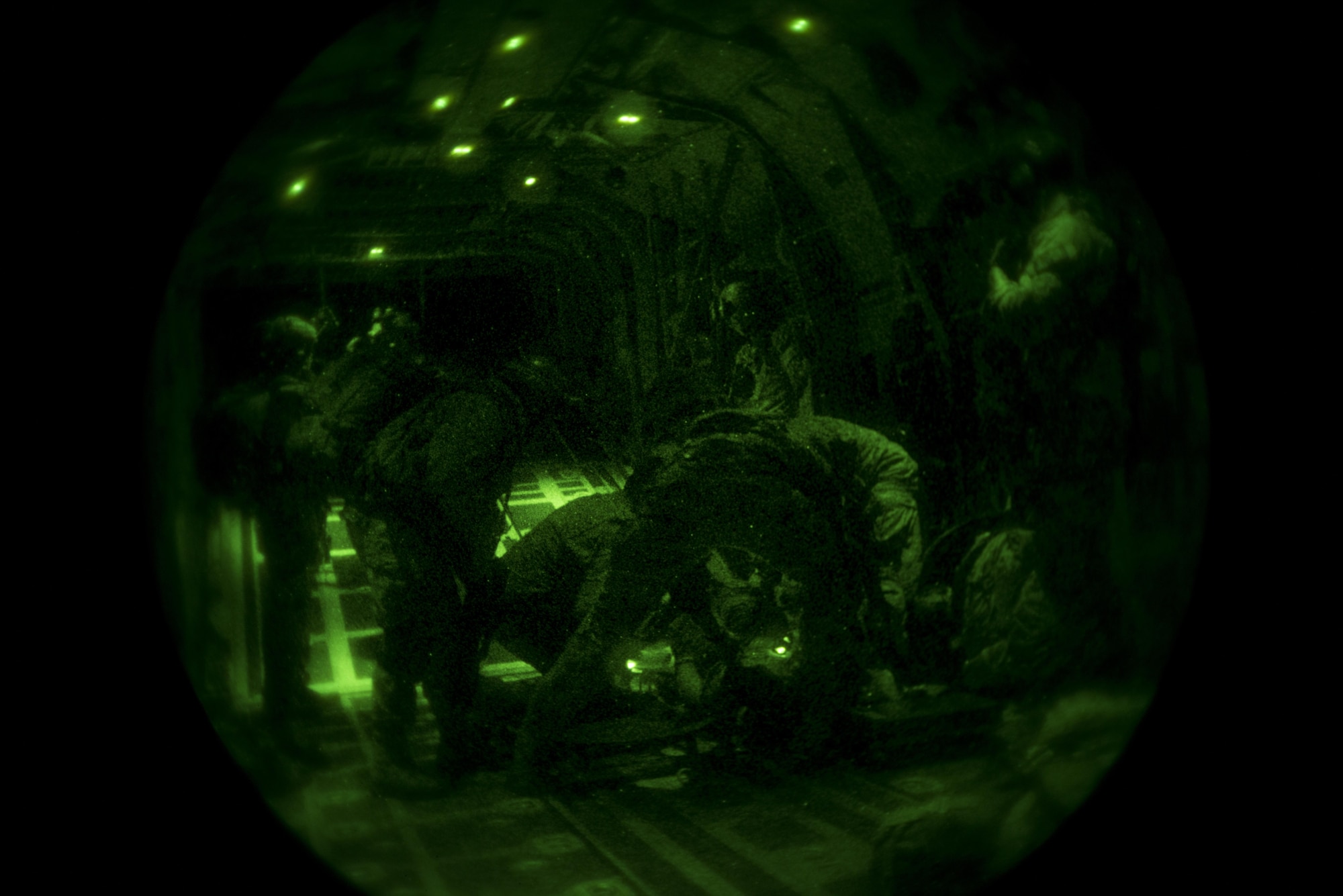 U.S. and Spanish air commandos work together to give care to a patient with a simulated gunshot wound on an MC-130J Commando II from the 352d Special Operations Wing during TRIDENT JUNCTURE, Nov. 2, 2015. The exercise involved U.S. and Spanish air commandos completing a rapid exfiltration from a remote airfield under simulated fire. (U.S. Air Force photo by 1st Lt. Chris Sullivan/Released)