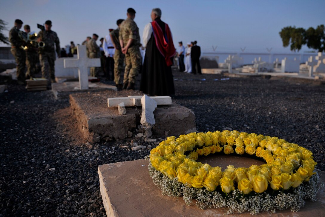 Greg Dorey, British ambassador to Ethiopia and Djibouti, and British Army Col. Mike Scott, defense attaché, lay a wreath of poppies during Remembrance Day service near Camp Lemonnier, Djibouti, Nov. 11, 2015. U.S. Air Force photo by Tech. Sgt. Dan DeCook