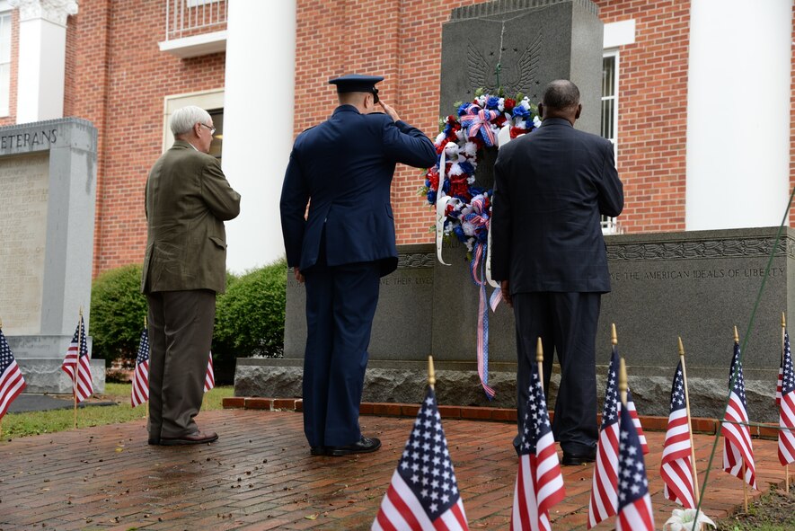 Harry Sanders, Lowndes County Board of Supervisors President, Col. John Nichols, 14th Flying Training Wing Commander, and Vice Columbus Mayor Gene Taylor, offer a salute after laying a wreath at the 2015 Veterans Day Ceremony Nov. 7 in Columbus, Mississippi. The wreath symbolizes the veterans of every branch who have served and are currently serving in today’s armed forces. (U.S. Air Force photo/Airman 1st Class John Day)