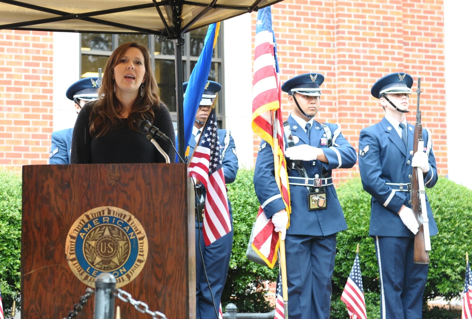 Emily Waites, wife of Maj. Michael Waites, 50th Flying Training Squadron Assistant Operations Officer, sings the National Anthem while the Columbus Air Force Base Honor Guard presents the colors during the Columbus, Mississippi, Veterans Day Ceremony Nov. 7 at the Lowndes County Courthouse. After the National Anthem, Pastor Jerry Mitchell of Mt. Vernon Church gave the invocation for the ceremony. (U.S. Air Force photo/Senior Airman Kaleb Snay)