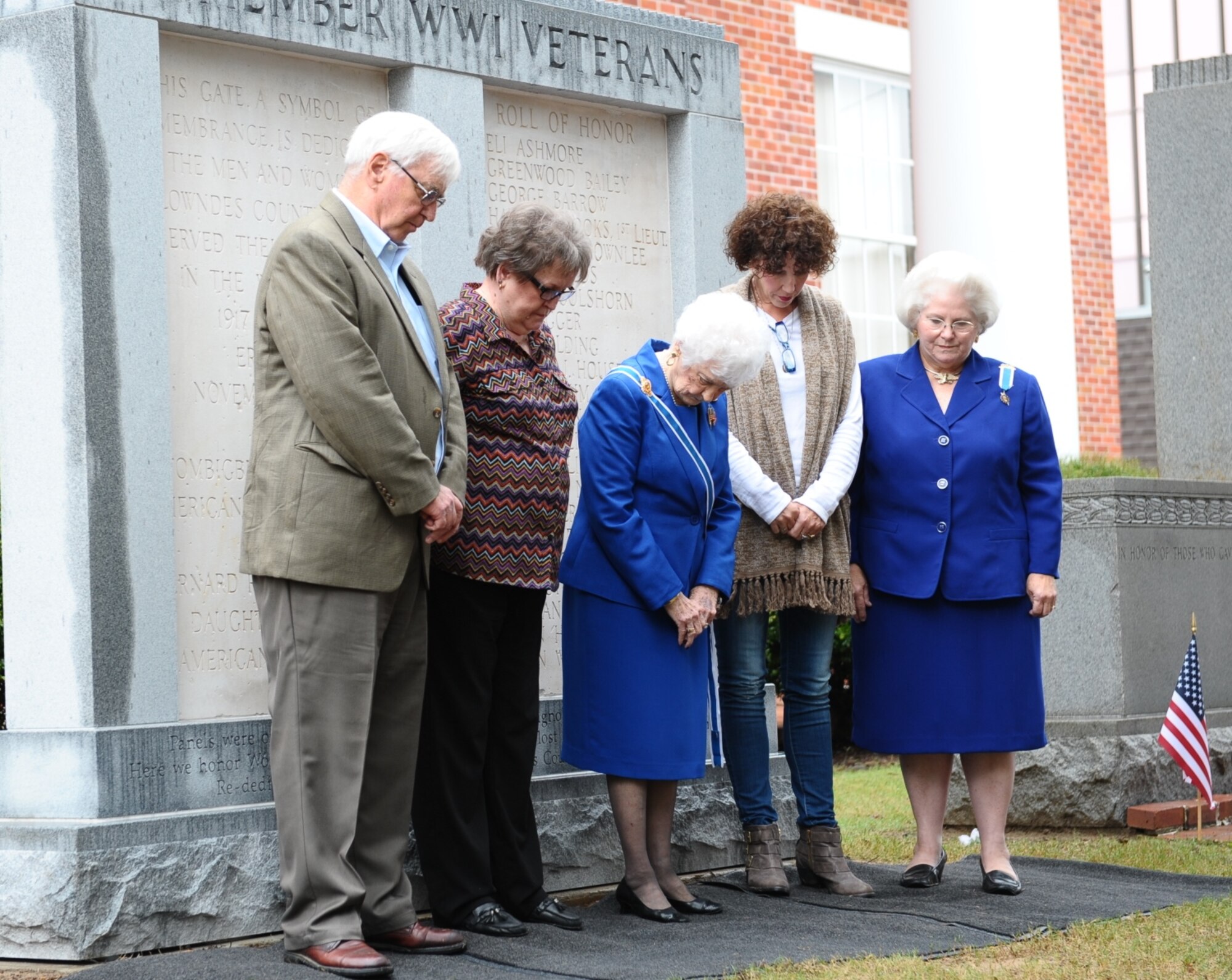 Members of the Lowndes County Board of Supervisors and the Daughters of the American Revolution bow their heads in a moment of prayer after rededicating a memorial monument during the Columbus, Mississippi, Veterans Day Ceremony Nov. 7 at the Lowndes County Courthouse. Alice Stallworth Lancaster, Regent of the Bernard Romans Chapter Daughters of the American Revolution, read 22 names of those who did not return and who are listed on the right plaque of the monument. (U.S. Air Force photo/Senior Airman Kaleb Snay)