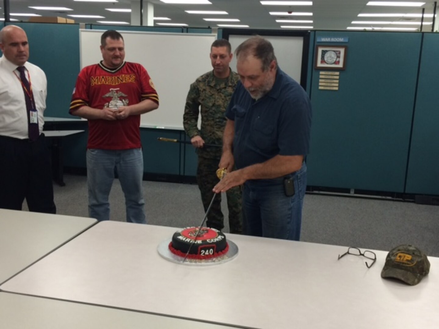 Shawn Searer, DLA Distribution Susquehanna, Pa., maintenance supervisor, carries on Marine Corps tradition by cutting the cake as the most senior Marine at the organization.