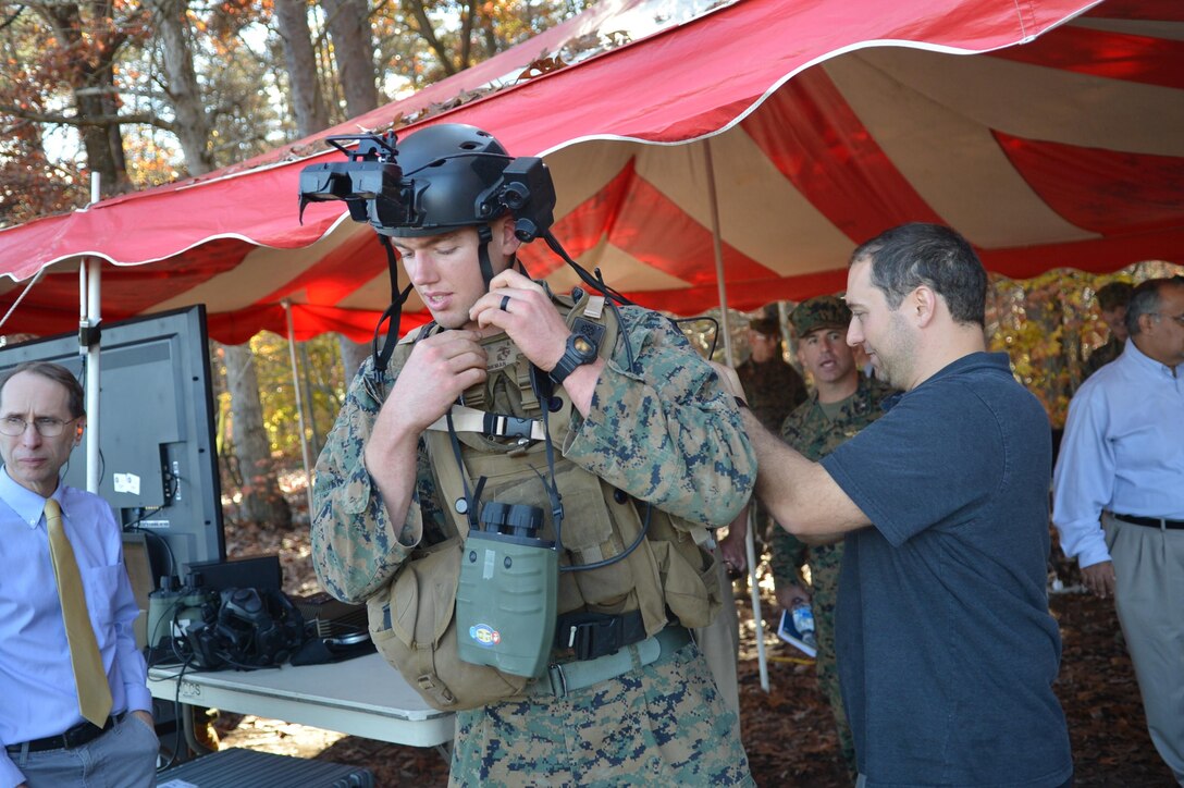 2nd Lt. Jacob Sparkman is fitted with the Augmented Immersive Team Trainer prior to a briefing about the new technology for Gen. Robert Neller, commandant of the Marine Corps, aboard Marine Corps Base Quantico on Nov. 5. The AITT, developed by the Office of Naval Research, allows Marines to transform any location into a dynamic training ground by injecting virtual images, indirect fire effects, aircraft, vehicles, simulated people, etc. onto a real-world view of one's surroundings.