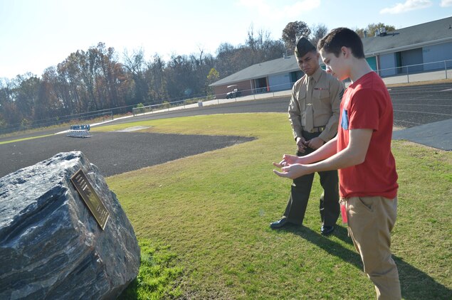 Gabe McGhee shows Sgt. Joshnino Supapo a rock dedicated to his brother Ryan, an Army ranger who was killed in Iraq in 2009, at Massaponax High School on Nov. 9. Supapo met Gabe, an eighth-grader at Thornburg Middle School, through Marine Corps Base Quantico's Adopt-a-School program.