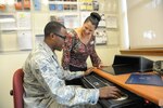 Senior Airman Princeton Blanchard (left), Air Force Personnel Center, receives guidance from Amanda Jalomo, Education Center education specialist, during the Virtual Education Fair Nov. 4 at the JBSA-Randolph Education Center. Virtual Education Fairs, help students search for schools, meet education career needs, live chat with representatives from participating schools and give financial aid options.  (U.S. Air Force photo by Joel Martinez/Released)