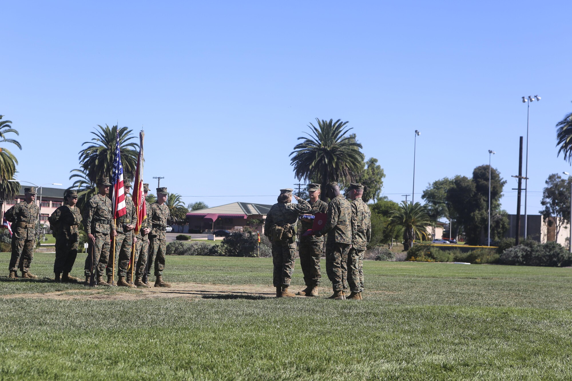 Master Gunnery Sgt. Diane Sharpe salutes the flag before her son hands it off to her during her retirement ceremony aboard Marine Corps Air Station Miramar, Calif., Nov. 6. Sharpe, retiring after 30 years, was the first female to reach the rank of master gunnery sergeant in her military occupational specialty.
