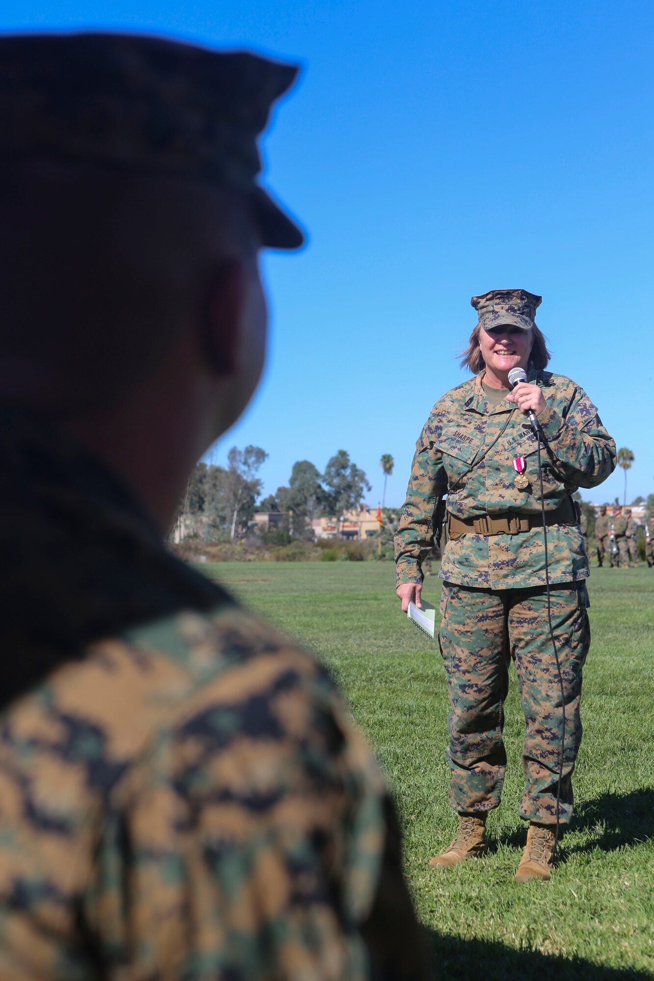 Master Gunnery Sgt. Diane Sharpe addresses her son while speaking during her retirement ceremony aboard Marine Corps Air Station Miramar, Calif., Nov. 6. Sharpe, retiring after 30 years, was the first female to reach the rank of master gunnery sergeant in her military occupational specialty.
