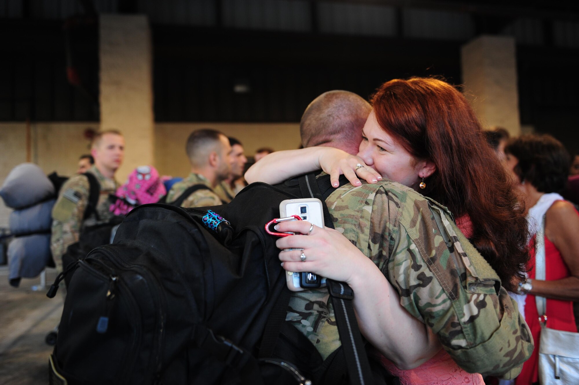 Senior Airman Saxton Wireman, an aerospace propulsion journeyman with the 4th Special Operations Squadron, hugs his wife during Operation Homecoming at Hurlburt Field, Fla., Nov. 6, 2015. Air Commandos with the 4th Special Operations Squadron returned from Southwest Asia after a four-month deployment. (U.S. Air Force photo by Senior Airman Meagan Schutter)