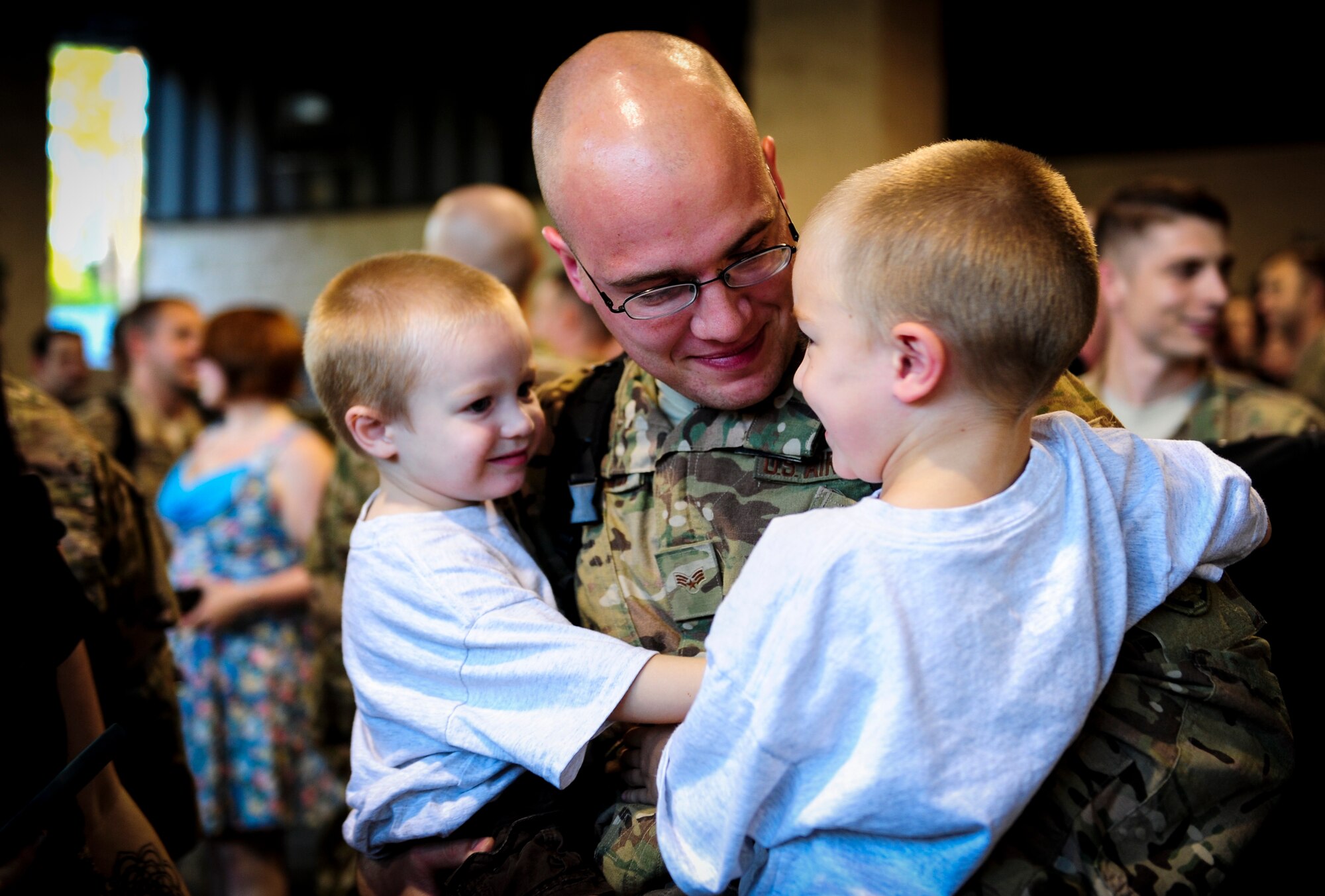 Senior Airman Ryan Johnson, a communications navigator journeyman with the 4th Special Operations Squadron, greets his children during Operation Homecoming at Hurlburt Field, Fla., Nov. 6, 2015. Air Commandos with the 4th Special Operations Squadron returned from deployment to their friends and family. (U.S. Air Force photo by Senior Airman Meagan Schutter)