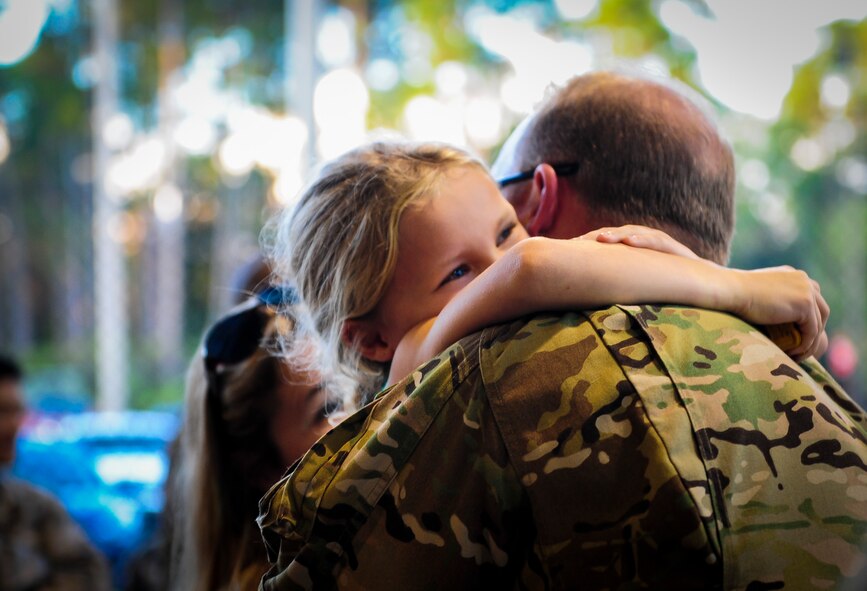 Maj. Aaron Mcneill with the 4th Special Operations Squadron hugs his daughter during Operation Homecoming at Hurlburt Field, Fla., Nov. 6, 2015. Operation Homecoming is a program created to welcome home Airmen returning from a recent deployment. (U.S. Air Force photo by Senior Airman Meagan Schutter)