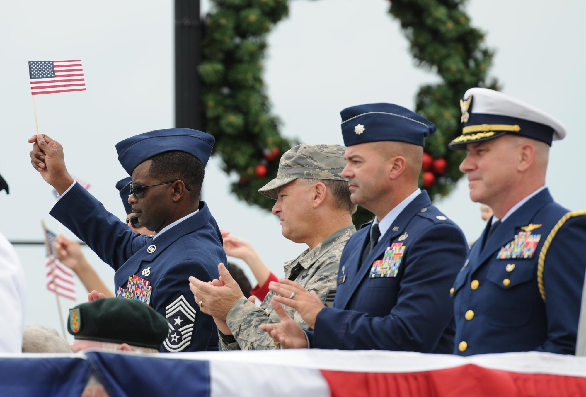 Chief Master Sgt. Harry Hutchinson, 81st Training Wing command chief, Keesler Air Force Base, Miss., waves an American Flag from the reviewing stands during the 15th Annual Gulf Coast Veterans Day Parade Nov. 7, 2015, in Gulfport, Miss. Keesler’s 81st Training Wing leadership, Honor Guard, 81st Training Group’s Drum and Bugle Corps, and Airmen participated in the event. (U.S. Air Force photo by Kemberly Groue)