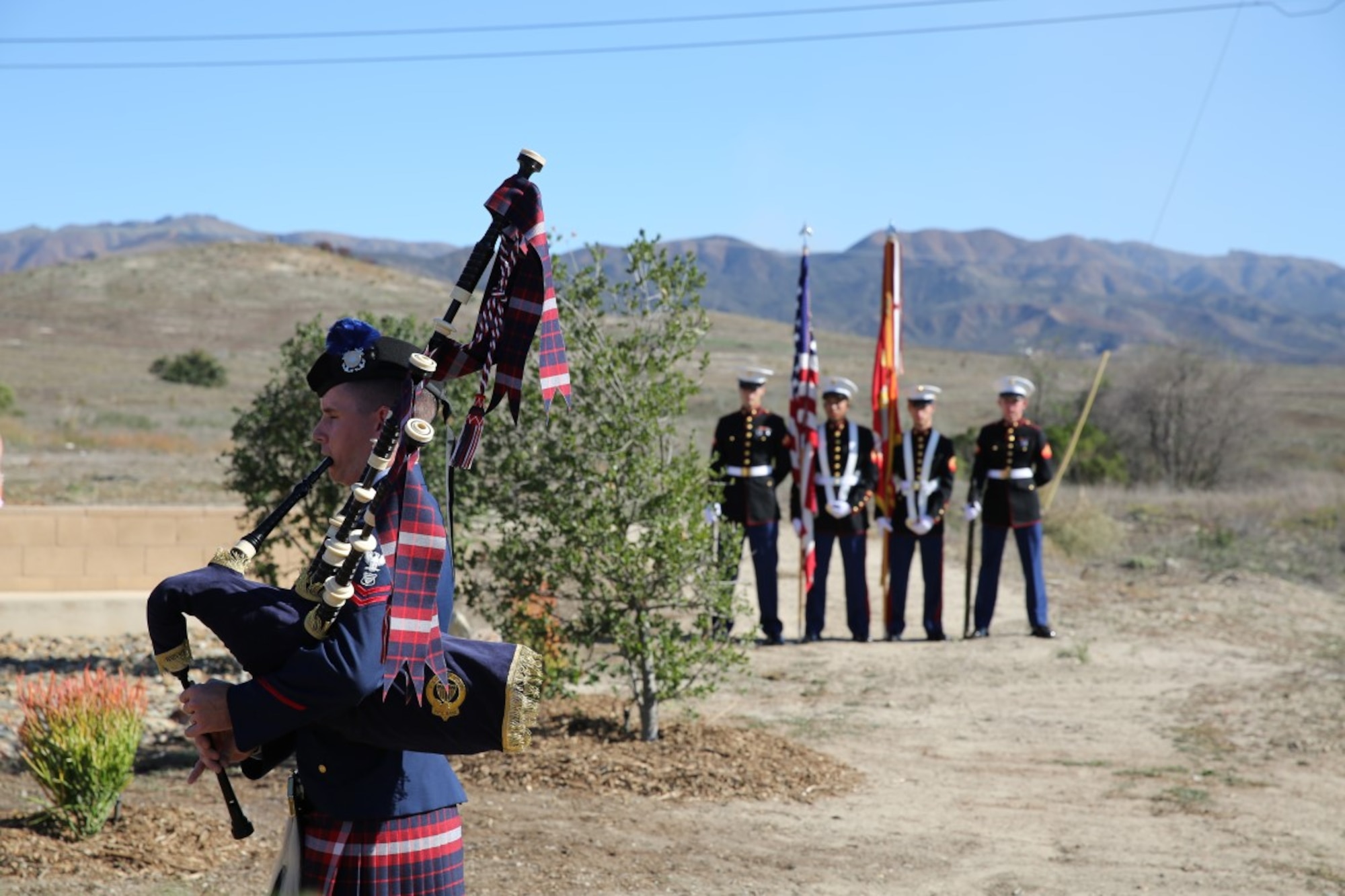 U.S. Coast Guard Petty Officer 2nd Class Jeremy Cook, left, plays "Amazing Grace" on a set of bagpipes during a ceremony honoring members of 2nd Battalion, 1st Marine Regiment who gave their lives during the Vietnam War. During the ceremony, plaques bearing the names of the fallen were dedicated in their honor at the Camp Horno Memorial Garden aboard Camp Pendleton. (U.S. Marine Corps photo by Sgt. Paris Capers/ Released)