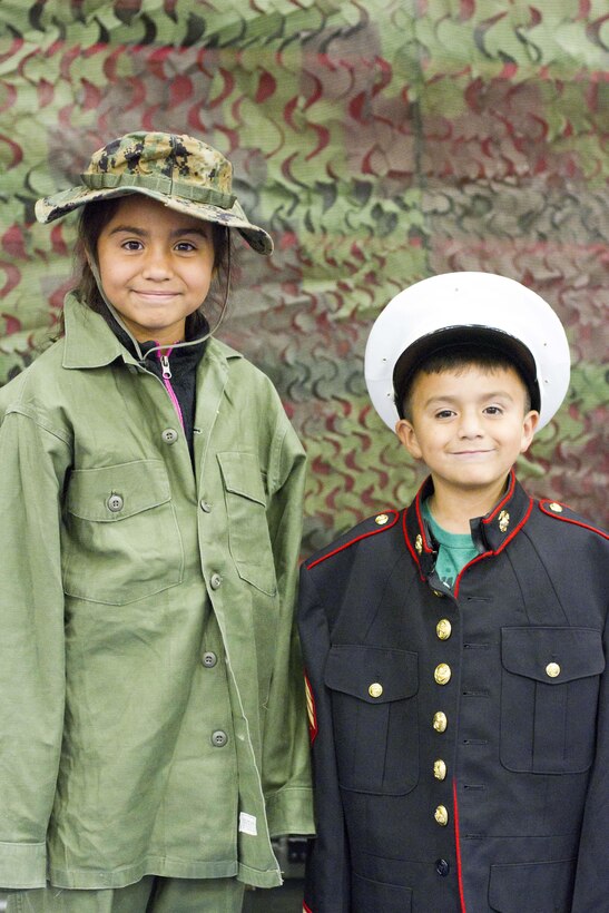 Sofia, 10, and Miguel, 6, play dress up in authentic military uniforms during the Military Kids Birthday Bash Nov. 5 at the Barber Physical Fitness Center. The sibling’s parents work at The Basic School aboard Marine Corps Base Quantico.