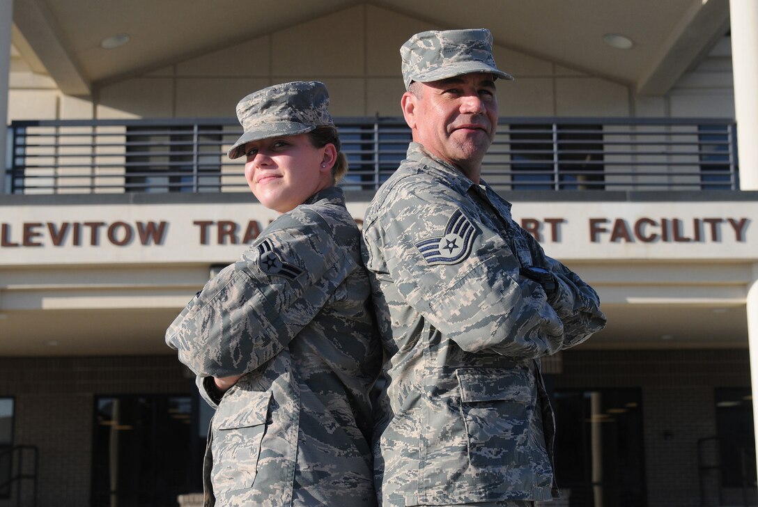 Air Force Airman 1st Class Breanna McDonald and her father, Air Force Staff Sgt. Michael McDonald, pose for a photo at the Levitow Training Support Facility parade field at Keesler Air Force Base, Miss., Oct. 15, 2015. The McDonalds attended cyber courses at the 336th Training Squadron at the same time and will be stationed together at the Air National Guard’s 178th Wing based in Springfield, Ohio. U.S. Air Force photo by Senior Airman Holly Mansfield