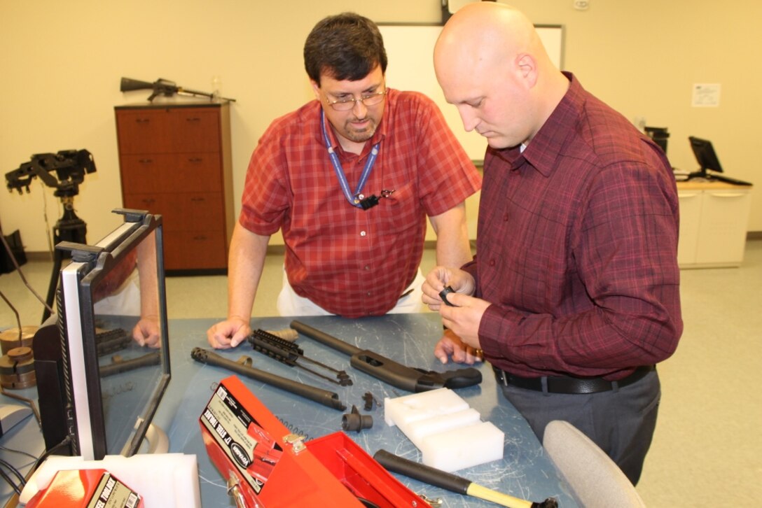 Special Warfare & Expeditionary Systems Department Weapon Systems Training Branch Manager John Brummett and Clarence Enlow