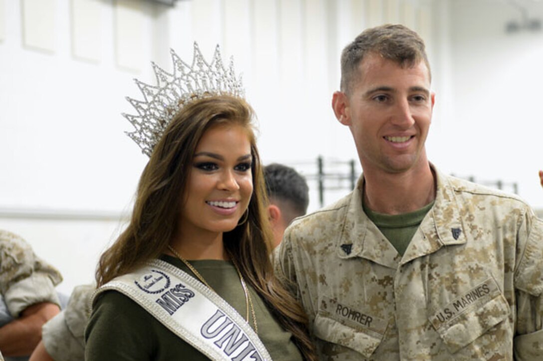 MARINE CORPS BASE QUANTICO, Va. — Corporal Jonathan Rohrer, a Marine with the 4th Light Armored Reconnaissance Battalion, poses with Miss United States, Summer Priester.