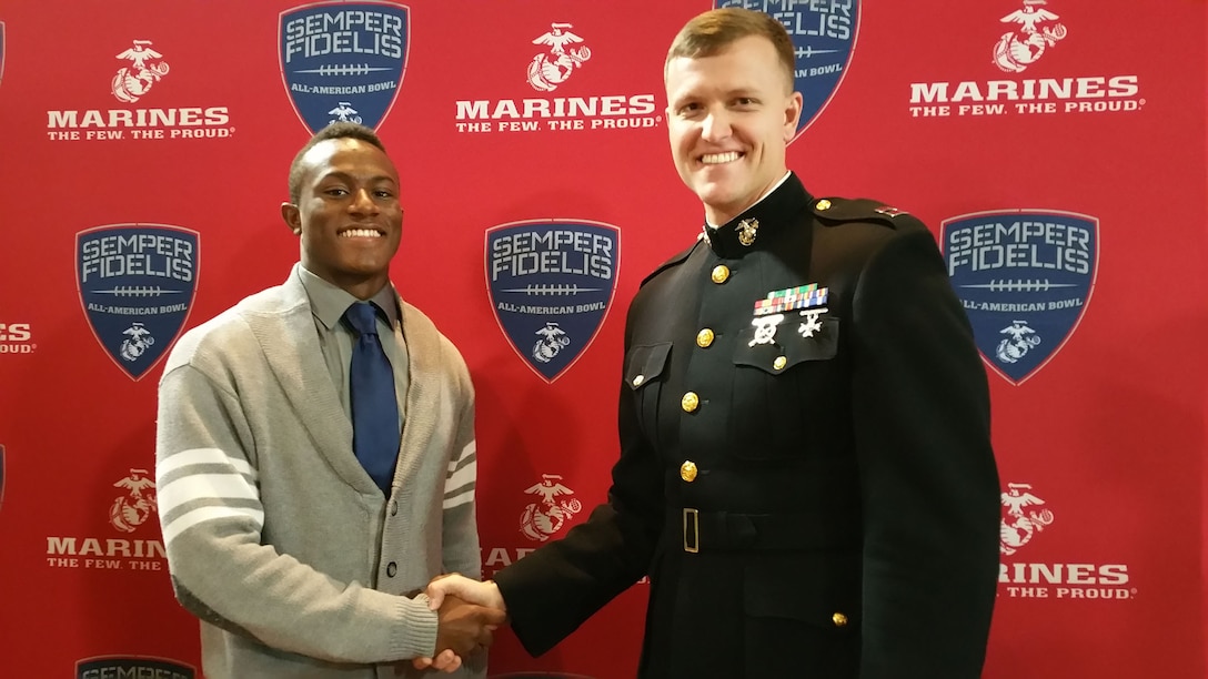 Capt. Joshua DeWalt, operations officer, Recruiting Station Sacramento, congratulates Darian West, wide receiver, Clovis West High School, for his selection for the Semper Fidelis All-American Bowl. Owens will play among the nation's elite football players during the game in January.