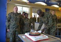 Capt. Ryan Martin, Command Naval Aviation Technical Training Detachment Eglin Marine liaison officer, prepares to serve a piece of the Marine Corps birthday cake at Eglin Air Force Base, Fla., Nov. 10, 2015. As per tradition, the oldest and youngest members of the unit were served the first slice of cake. (U.S. Air Force Photo/Senior Airmen Andrea Posey)