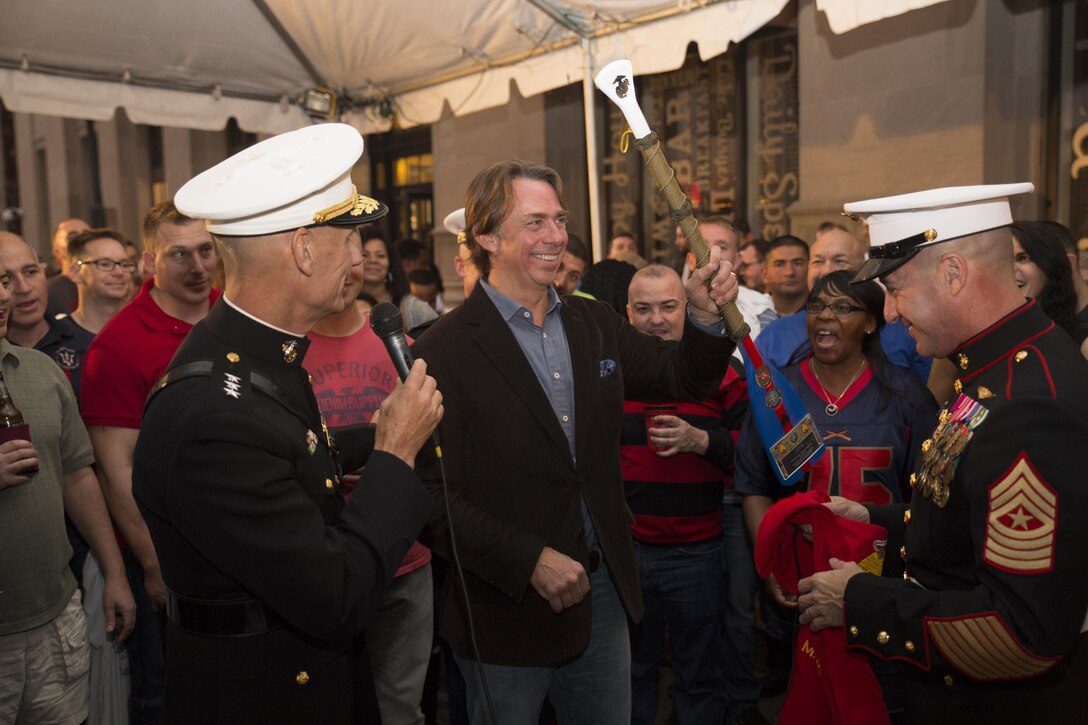 Lt. Gen. Rex C. McMillian (left), commander of Marine Forces Reserve, and Sgt. Maj. Anthony A. Spadaro (right), sergeant major of MARFORRES, present John Besh, chef and former Marine sergeant, with a commemorative paddle at Luke Restaurant in New Orleans, Nov. 10, 2015. The gift was given to thank Besh for hosting this event at his restaurant to celebrate the 240th Marine Corps Birthday. (U.S. Marine Corps photo by Cpl. Ian Leones/Released)