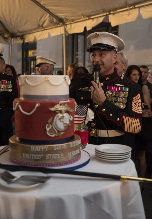 Sgt. Maj. Anthony A. Spadaro, sergeant major of Marine Forces Reserve, searches the crowd for the oldest and youngest Marine to participate in a cake-cutting ceremony in celebration of the 240th Marine Corps Birthday at Luke restaurant in New Orleans, Nov. 10, 2015. The passing of the cake from the oldest Marine to the youngest Marine symbolizes the passing of knowledge and traditions from one generation to the next. (U.S. Marine Corps photo by Cpl. Ian Leones/Released)