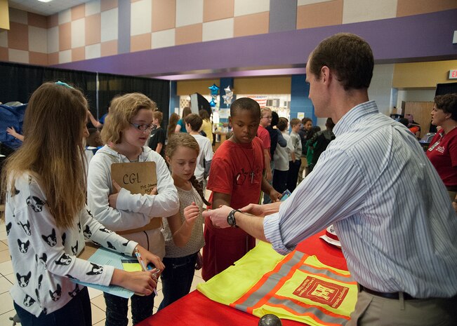 John Nevels, a structural engineer with the Engineering and Support Center, Huntsville shows Mill Creek Elementary School fifth-graders a primary fragment from previous blast demonstration during a STEAM event Nov. 10.