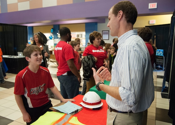 John Nevels, a structural engineer with the Engineering and Support Center, Huntsville explains his role in the Explosives Safety Program to Mill Creek Elementary School sixth-grader Joey Crider during a STEAM event Nov. 10.
