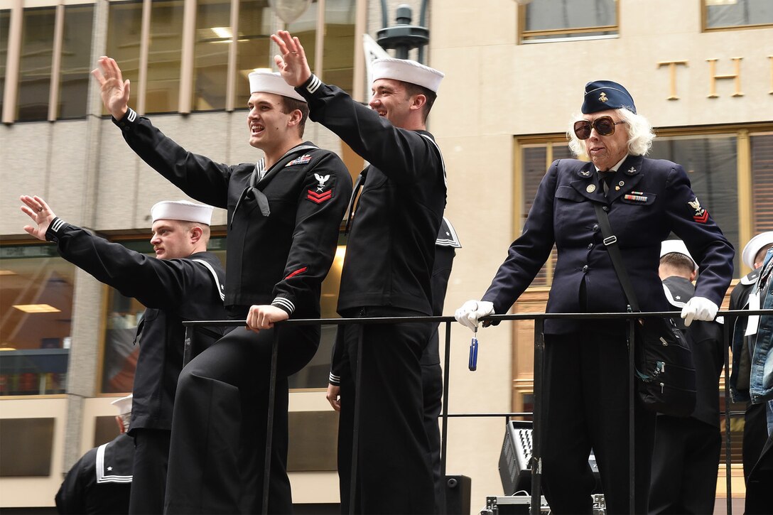 A Navy veteran, right, joins sailors aboard the Navy float during the 2015 New York City Veterans Day Parade in New York, Nov. 11, 2015. U.S. Navy photo by Petty Officer 1st Class Brian McNeal