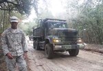 First Lt. Darrion Lemon guides a driver along as he works with other U.S. Army engineers with the South Carolina National Guard to repair roads in Manning, S.C., Nov. 5, 2015. The engineers assigned to the 178th Engineer Battalion and 122nd Engineer Battalion are supporting recovery efforts after the state was impacted by historic flooding that damaged roads and infrastructure in October 2015. 