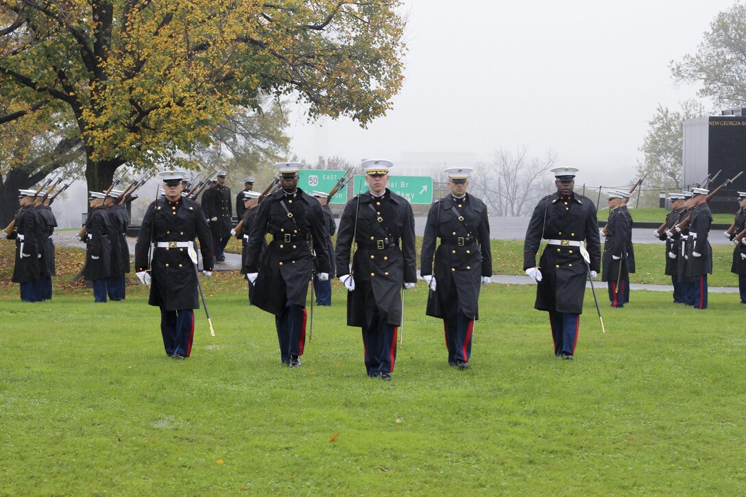 The parade staff from Marine Barracks Washington, D.C. marches during the Marine Corps' Birthday Wreath Laying Ceremony at the Marine Corps War Memorial, Arlington, Va., Nov. 10, 2015. The wreath laying ceremony honored the Corps’ 240th birthday. The official party for the ceremony was Gen. Robert Neller, commandant of the Marine Corps, and Sen. Daniel Sullivan, ceremony guest of honor.(Official U.S. Marine Corps Photos by Gunnery Sgt. Damon Davoren/Released)