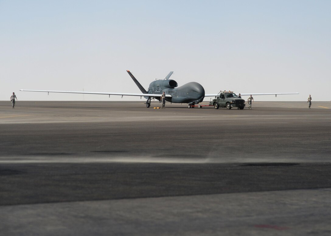 U.S. Airmen assigned to the 380th Expeditionary Aircraft Maintenance Squadron, recover an EQ-4 Global Hawk unmanned aircraft at an undisclosed location in Southwest Asia, Nov. 11, 2015. The EQ-4 Global Hawk nicknamed the ‘Workhorse’ by local maintainers, completed its 500th sortie on Veterans Day. (U.S. Air Force photo by Tech. Sgt. Frank Miller/Released)