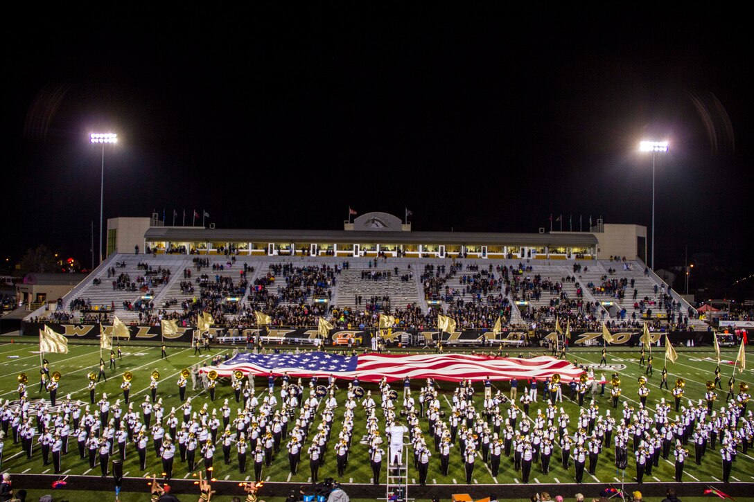 Marine Poolees from Kalamazoo, Mich., helped unfurl a 30-yard-flag across the 50-yard-line during the Veteran's Day halftime show at Western Michigan University's football game, November 11, 2015.

