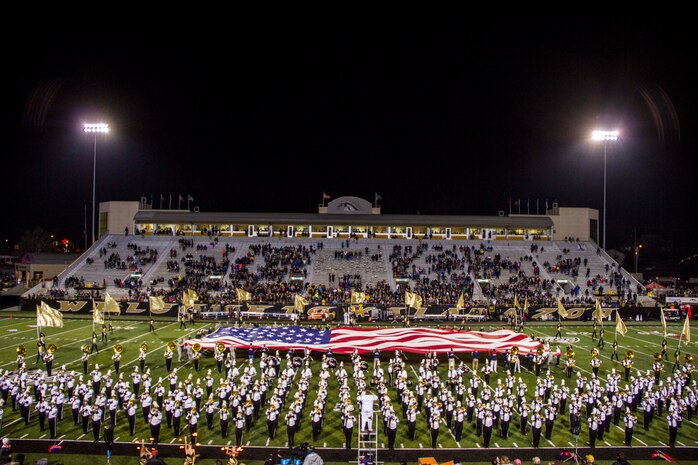 Marine Poolees from Kalamazoo, Mich., helped unfurl a 30-yard-flag across the 50-yard-line during the Veteran's Day halftime show at Western Michigan University's football game, November 11, 2015.

