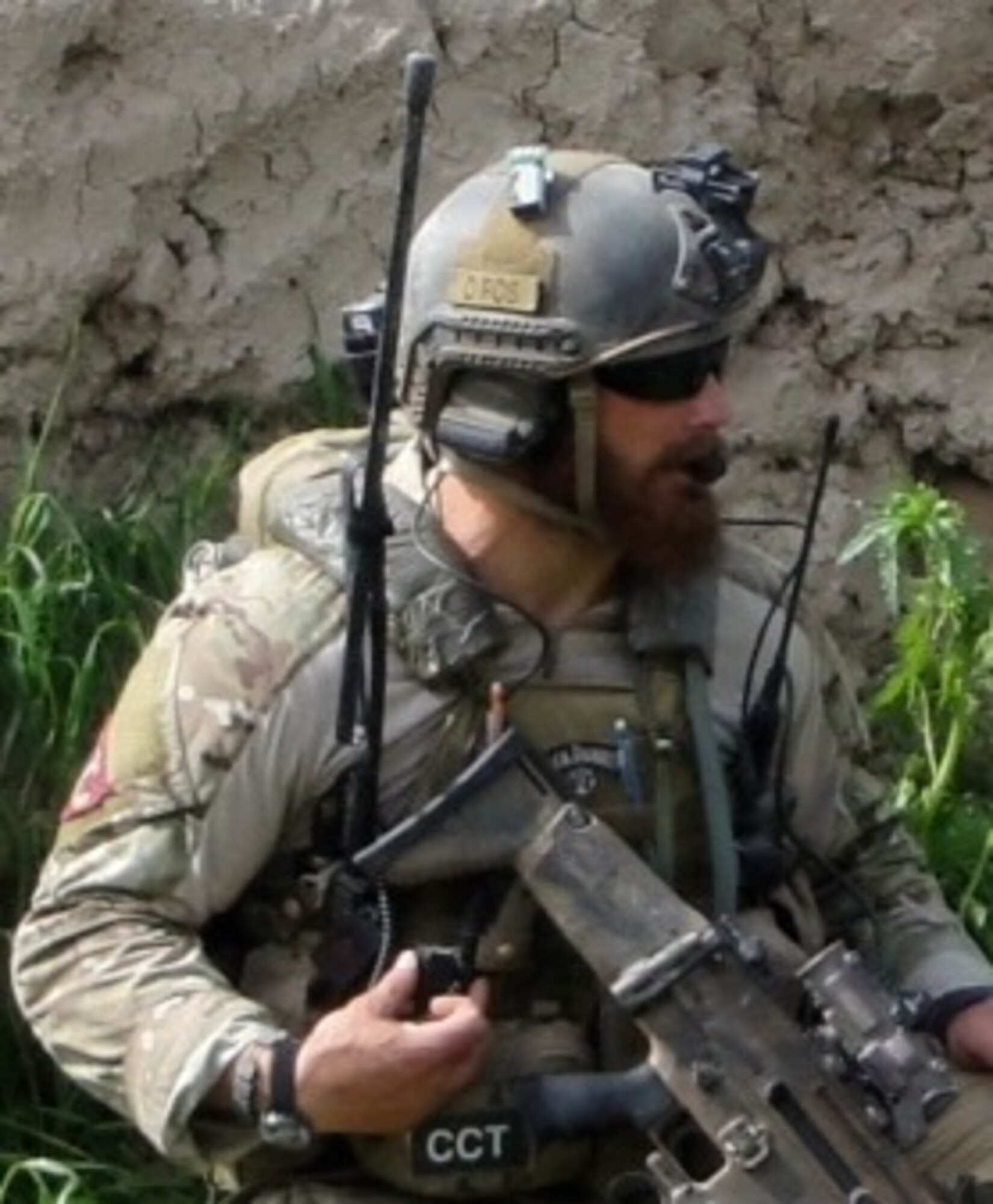 Tech. Sgt. Yuri Miller, 334th Training Squadron instructor supervisor, speaks to pilots over his headset during a special operations deployment earlier in his career. Miller is a combat controller, and exemplifies wingmanship, whether he's downrange or on Keesler training the next generation of combat controllers, by ensuring he always gives his best, no matter the situation.