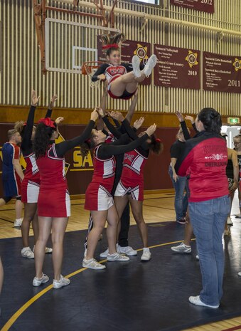 Kinnick High School cheerleaders execute cheer techniques learned during the Far East Cheerleading tournament at Matthew C. Perry High School gymnasium at Marine Corps Air Station Iwakuni, Japan, Nov, 3, 2015. The ultimate goal of cheer week is to provide student athletes a positive athletic experience that reinforces the values of a good sportsman.(U.S. Marine Corps photo by Cpl. Nicole Zurbrugg/Released)