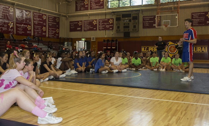 Kip Winterowd, National Cheerleaders Association director of curriculum, gives cheerleaders a pep talk during cheer week at Matthew C. Perry High School gymnasium at Marine Corps Air Station Iwakuni, Japan, Nov. 2, 2015. This is the 3rd year in a row MCAS Iwakuni hosted the Far East Cheerleading tournament and 12 teams from the Department of Defense Education Activity Pacific participated in a week of learning and fun.(U.S. Marine Corps photo by Cpl. Nicole Zurbrugg/Released)
