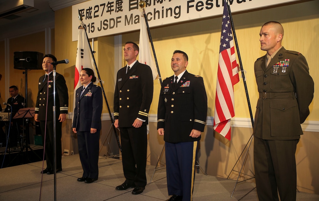 Band directors from the U.S. Marine Corps, U.S. Navy, U.S. Army, U.S. Air Force and the Republic of Korea Navy stand together Nov. 11 to be introduced to fellow services and nations before they perform during the Japan Self-Defense Force Marching Band Festival in Tokyo, Japan. The festival provides an ample opportunity to share music and military culture between partner nations in the Asia-Pacific region. 