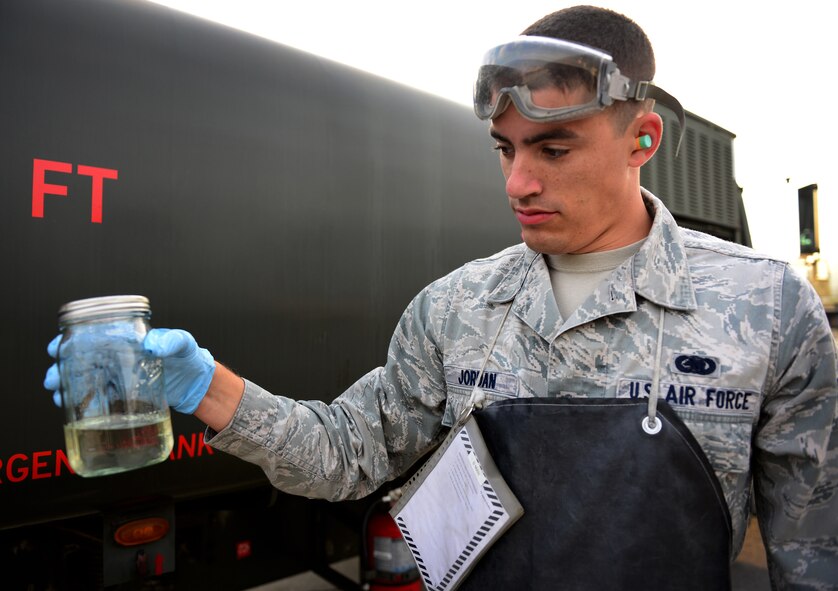 Senior Airman Joshua Jordan, 51st Logistics Readiness Squadron preventive maintenance technician, displays a sample jar of JP-8 jet fuel taken from one of the R-11 mobile fuel truck at Osan Air Base, Republic of Korea, Oct. 15, 2015. Daily samples are taken from each truck to test the fuel for excess water and contaminants. (U.S. Air Force photo/Staff Sgt. Amber Grimm)