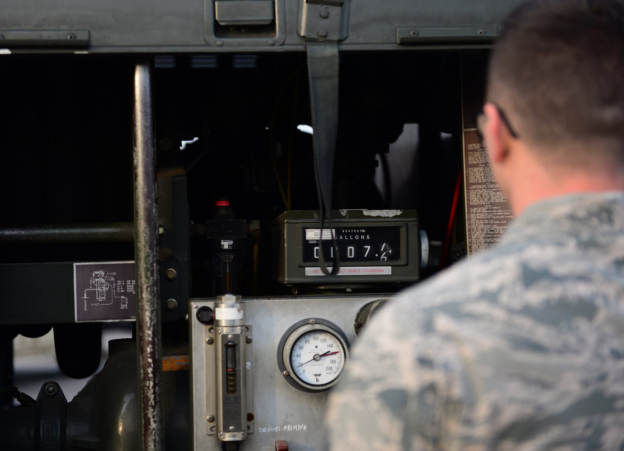 A 51st Logistics Readiness Squadron petroleum, oils, and lubricants Airman, monitors the amount of fuel being drained for testing from an R-11 mobile fuel truck at Osan Air Base, Republic of Korea, Oct. 15, 2015. The fuel stored in the trucks must be checked daily to ensure the fuel has not become contaminated by excess water or sediment. (U.S. Air Force photo/Staff Sgt. Amber Grimm)