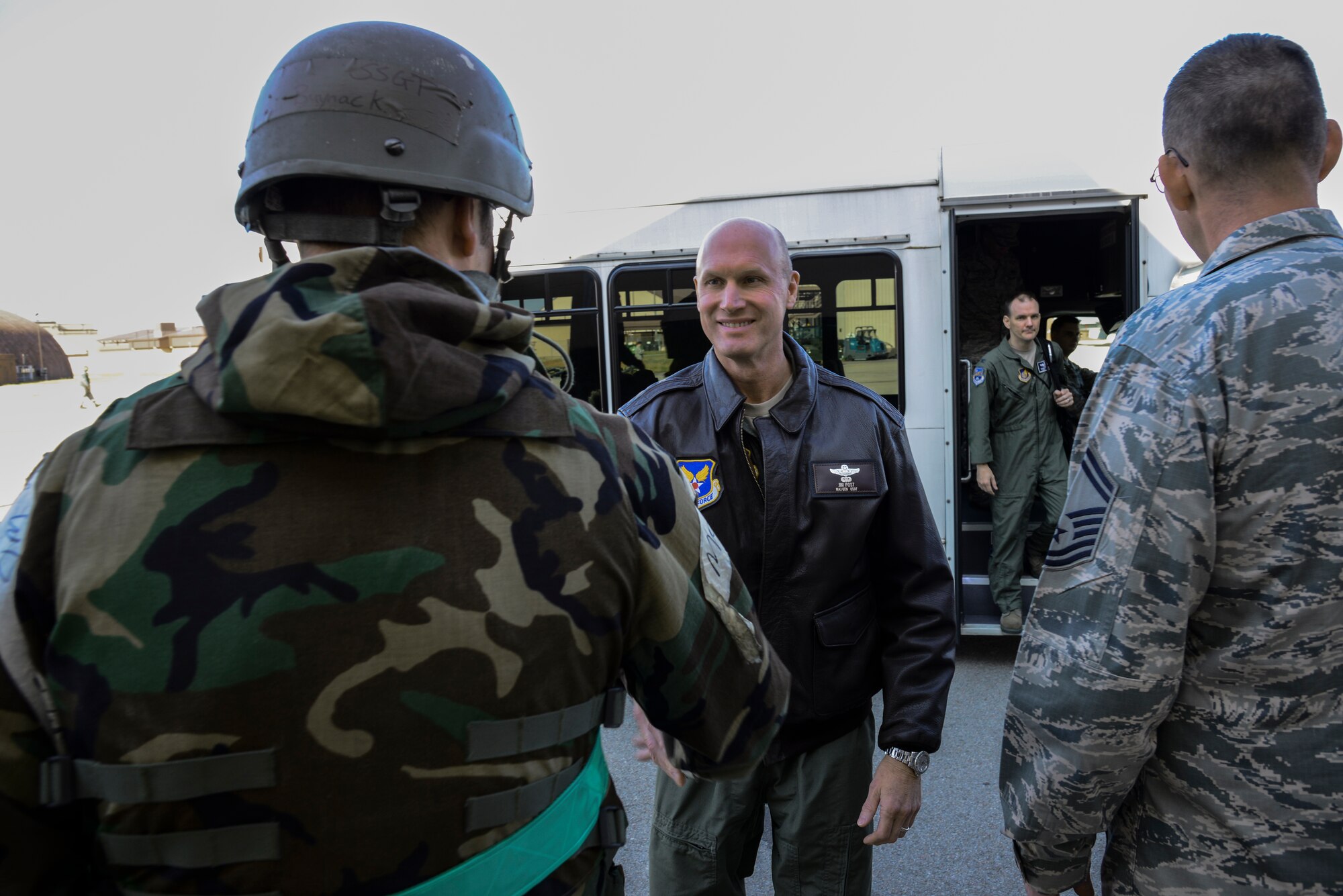 Maj. Gen. James N. Post III, Headquarters Air Force director of current operations and deputy chief of staff for operations (middle), greets Staff Sgt. Stephen Buynack, 51st Aircraft Maintenance Squadron noncommissioned officer in charge of A-10 programs, prior to an explanation of flightline decontamination procedures at Osan Air Base, Republic of Korea, Nov. 12, 2015. The current operations directorate encompasses five divisions, the Air Force Operations Group, and the Air Force Agency for Modeling and Simulation, which are responsible for policy, guidance, and oversight of Air Force current operations in air, space and cyberspace. Post was at Osan to discuss some of the inherent challenges associated with training and readiness at one of the most forward, non-deployed air bases in the world. (U.S. Air Force photo/Tech. Sgt. Travis Edwards)