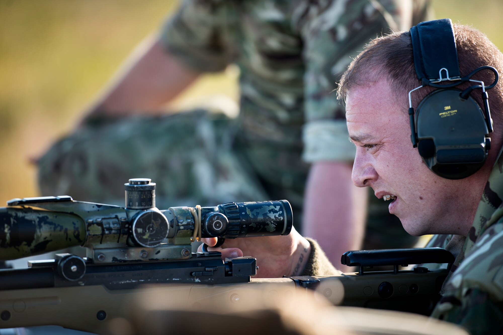 A sniper from No. 15 Squadron Royal Air Force Regiment checks his rifle after taking a shot during exercise GLOBAL EAGLE, Oct. 30, 2015, at Avon Park Air Force Range, Fla. During the sniper competition, teams from each participating nation practiced stealthy movements and firing while under pressure. (U.S. Air Force photo by Senior Airman Ryan Callaghan/Released)

