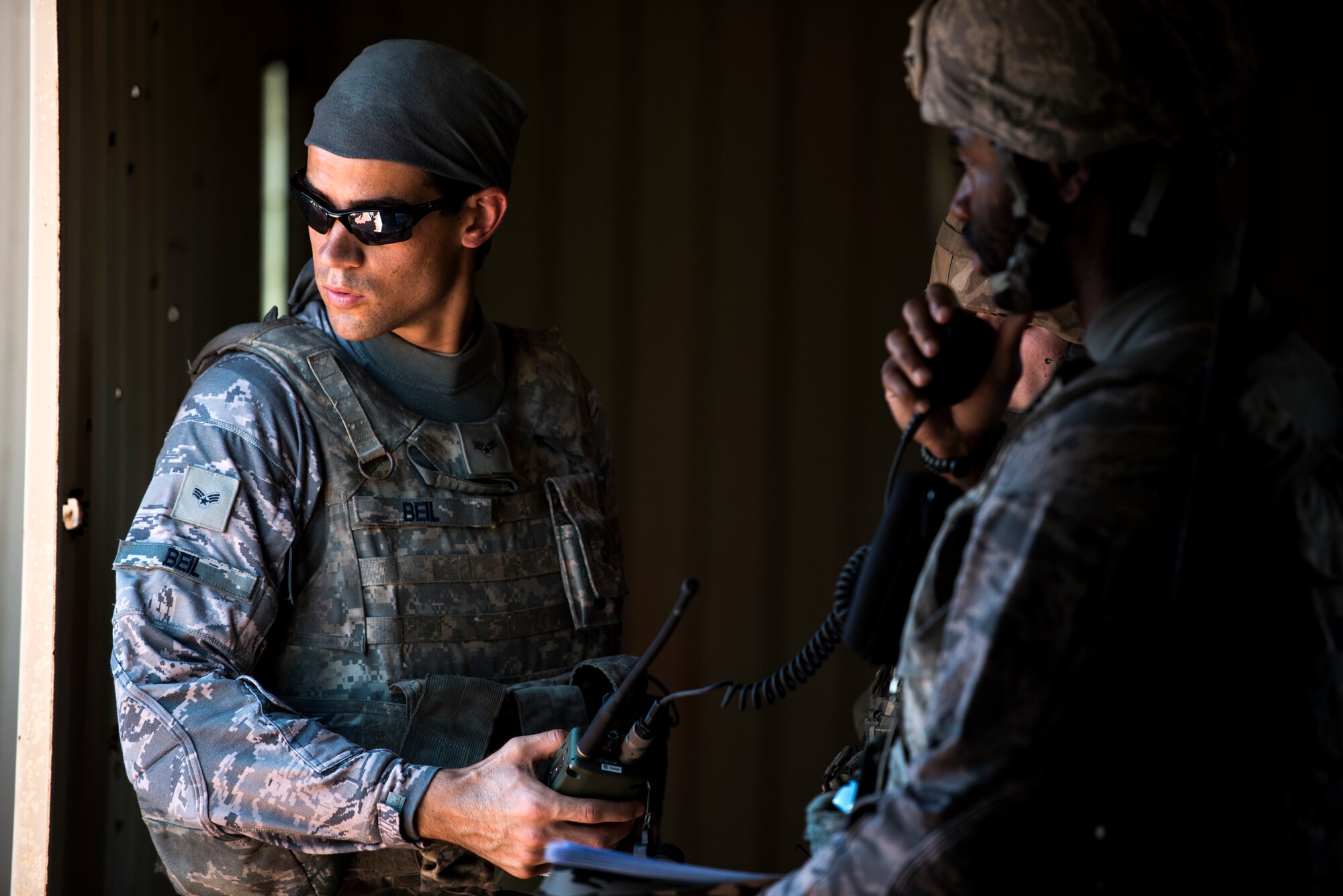 U.S. Air Force Senior Airman Christopher Beil, left, 822nd Base Defense Squadron fireteam member, and Staff Sgt. Marcus McComb, 822nd BDS fireteam leader, perform a radio check during exercise GLOBAL EAGLE, Oct. 29, 2015, at Avon Park Air Force Range, Fla. During the two-week exercise, members of the 822nd BDS, the Royal Air Force Regiment and the French air force conducted counter-improvised explosive device procedures, tactical combat casualty care and combatives. (U.S. Air Force photo by Senior Airman Ryan Callaghan/Released)
