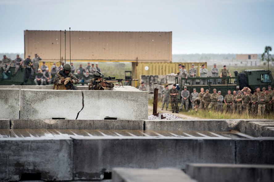 A sniper and a joint terminal attack controller from the French air force sit on top of a building during a capabilities demonstration during exercise GLOBAL EAGLE, Oct. 21, 2015, at Avon Park Air Force Range, Fla. GLOBAL EAGLE is designed to exchange tactics, techniques and procedures to facilitate interoperability between allied nations. (U.S. Air Force photo by Senior Airman Ryan Callaghan/Released)

