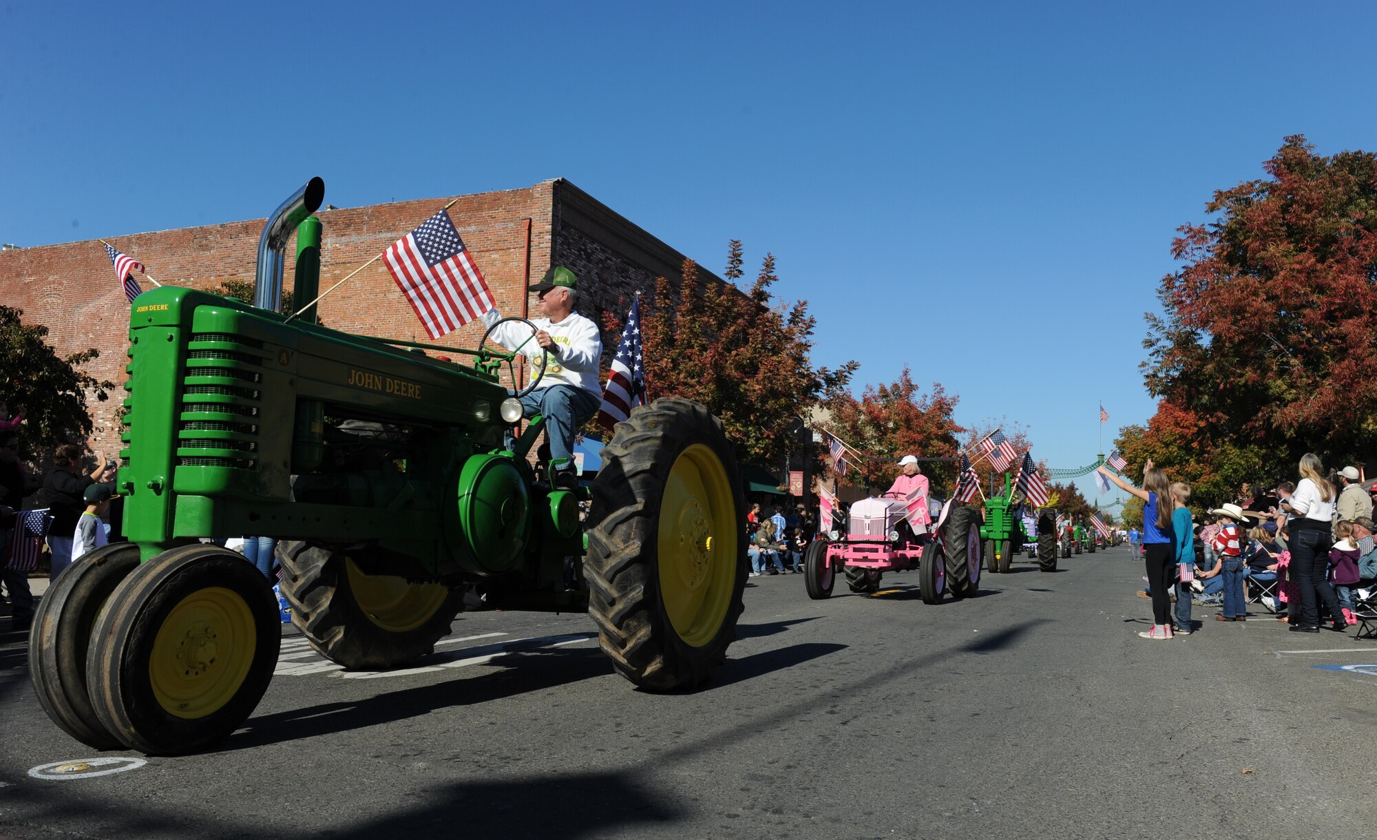 Local farmers ride vintage tractors during the Yuba/Sutter Veterans Day Parade in Marysville, California, Nov. 11, 2015. The local counties have a rich history in agriculture. (U.S. Air Force photo by Staff Sgt. Robert M. Trujillo/Released)

