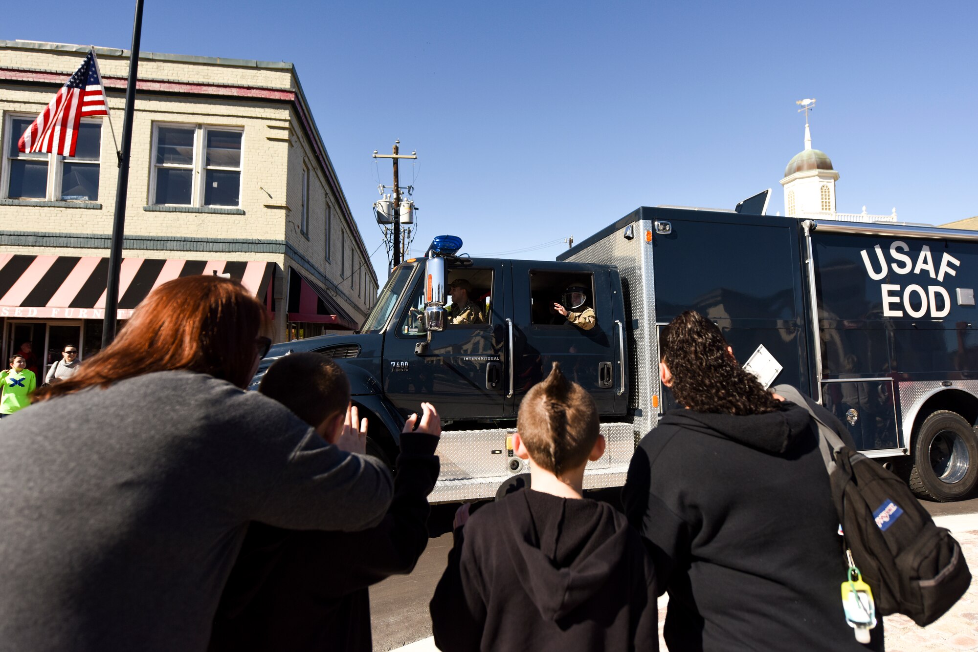 Members of the 4th Civil Engineer Squadron explosive ordnance disposal flight drive through the annual Veterans’ Day Parade, Nov. 11, 2015, in downtown Goldsboro, North Carolina. The EOD flight and several other local and on-base agencies participated in the parade to show their support for the nation’s veterans. (U.S. Air Force photo/Senior Airman Brittain Crolley)