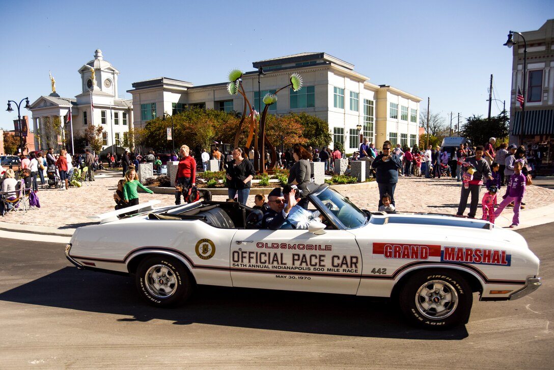 Chief Master Sgt. Jeffrey Craver, 4th Fighter Wing command chief, waves to the crowd during the annual Veterans’ Day Parade, Nov. 11, 2015, in downtown Goldsboro, North Carolina. Craver was selected to be the honorary grand marshal for the parade. (U.S. Air Force photo/Senior Airman Brittain Crolley)