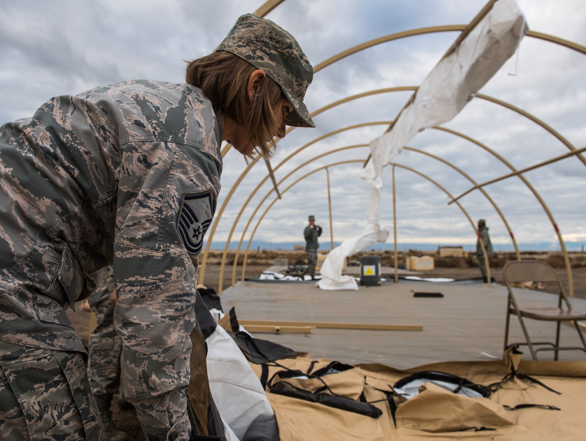 Master Sgt. Ann Mitchell, 366th Force Support Squadron sustainment flight superintendent, deconstructs an Alaskan SSS multi-purpose tent during Gunfighter Flag 16-1, Nov. 6, 2015, at Mountain Home Air Force Base, Idaho. The tents provide shelter for lodging, food preparation and briefings areas. (U.S. Air Force photo by Airman 1st Class Connor J. Marth)