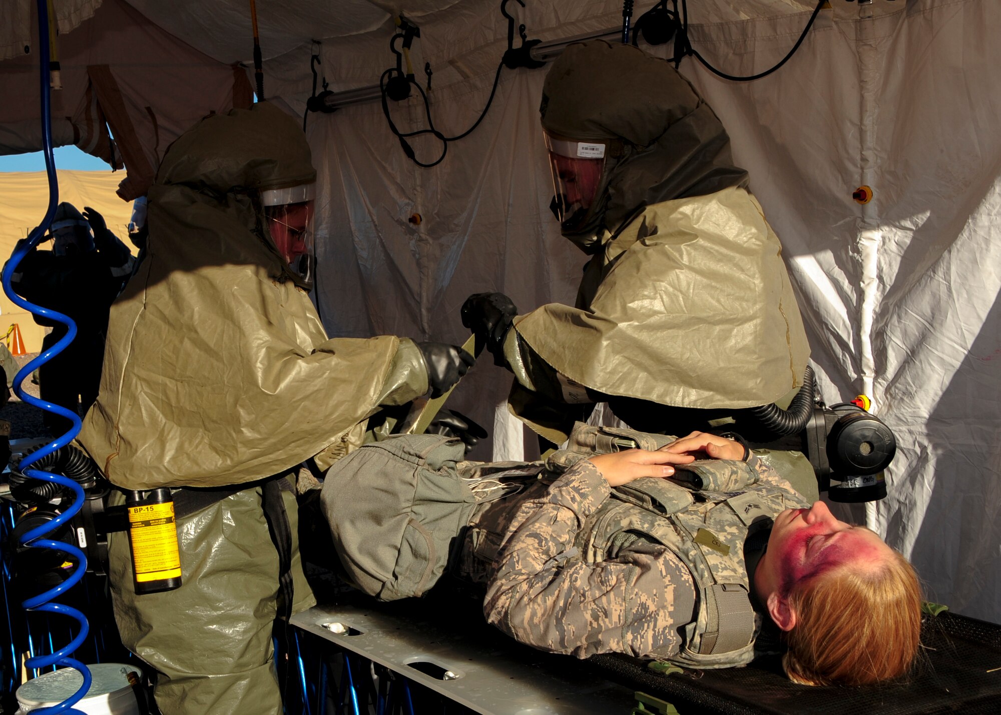 U.S.; Air Force Airman 1st Class Caitlin Obee; 355th Security Forces Squadron defender; tests Airmen’s readiness by simulating fatal wounds during Exercise BUSHWHACKER 15-07 at Davis-Monthan Air Force Base; Ariz.; Nov. 5; 2015. During the exercise; Obee and other Airmen acted as patients and used moulage to create a realistic experience; allowing medical Airmen to perceive the wounds they were treating. (U.S. Air Force photo by Airman Basic Nathan H. Barbour/Released)