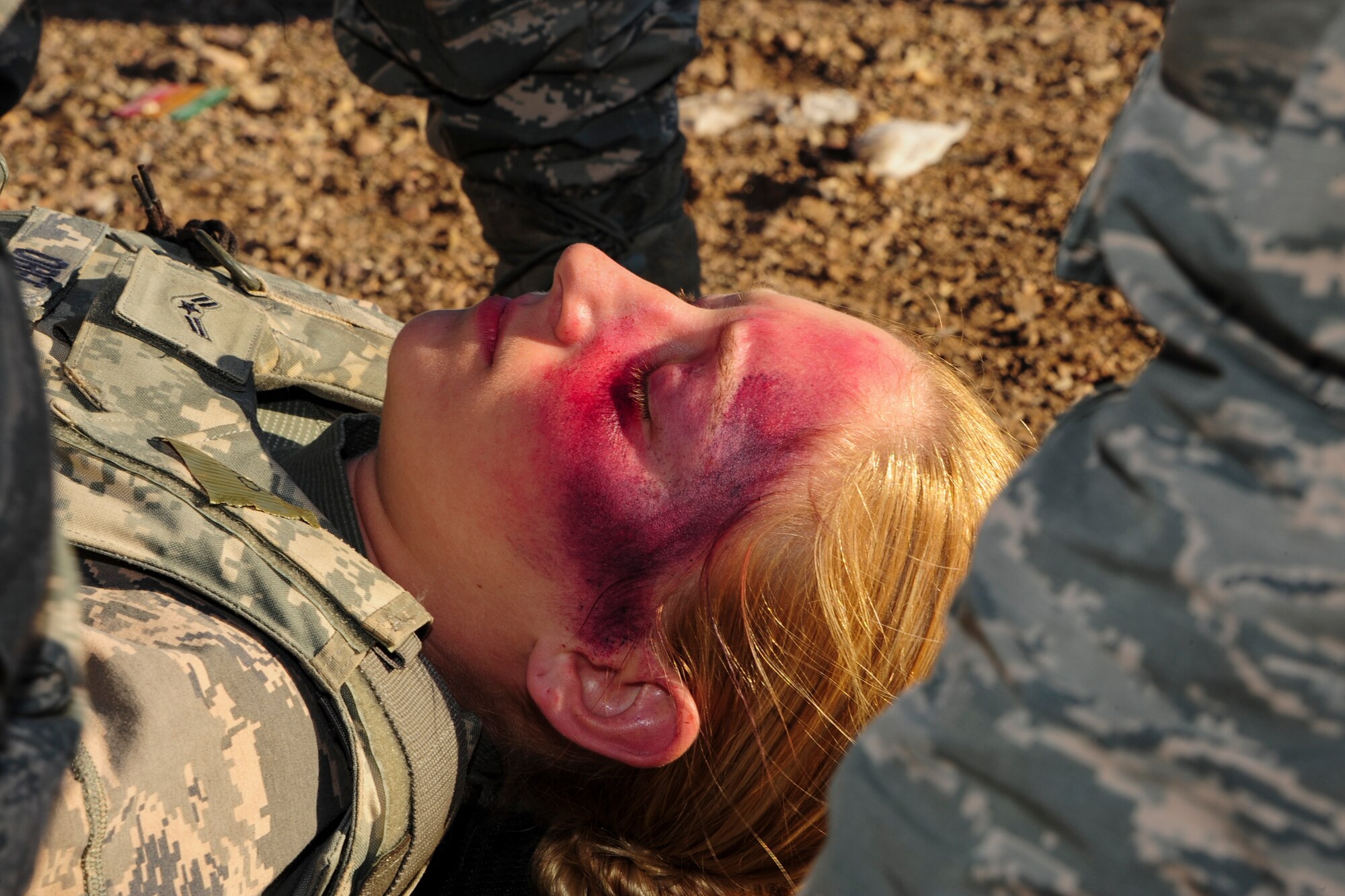 U.S.  Air Force Airman 1st Class Caitlin Obee, 355th Security Forces Squadron defender, acts as a simulated patient with fatal wounds during Exercise BUSHWHACKER 15-07 at Davis-Monthan Air Force Base, Ariz., Nov. 5, 2015. During the exercise, Obee and other Airmen acted as patients and used moulage to create a realistic experience, allowing medical Airmen to perceive the wounds they were treating. (U.S. Air Force photo by Airman Basic Nathan H. Barbour/Released)