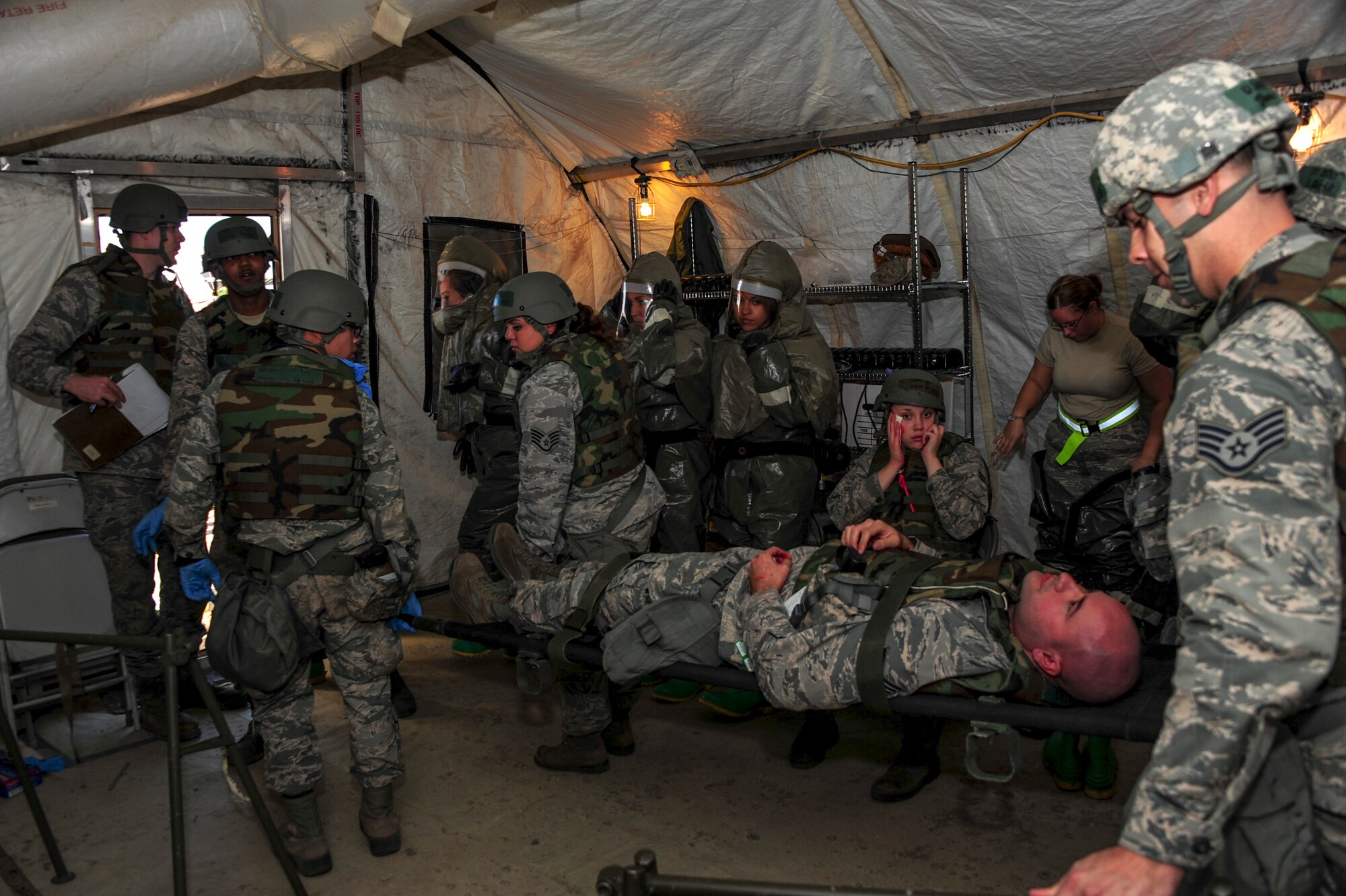 U.S. Airmen transport a simulated casualty during Exercise BUSHWHACKER 15-07 at Davis-Monthan Air Force Base, Ariz., Nov. 5, 2015. During the exercise, Airmen acted as patients and used moulage to create a realistic experience, allowing medical Airmen to perceive the wounds they were treating. (U.S. Air Force photo by Airman Basic Nathan H. Barbour/Released)