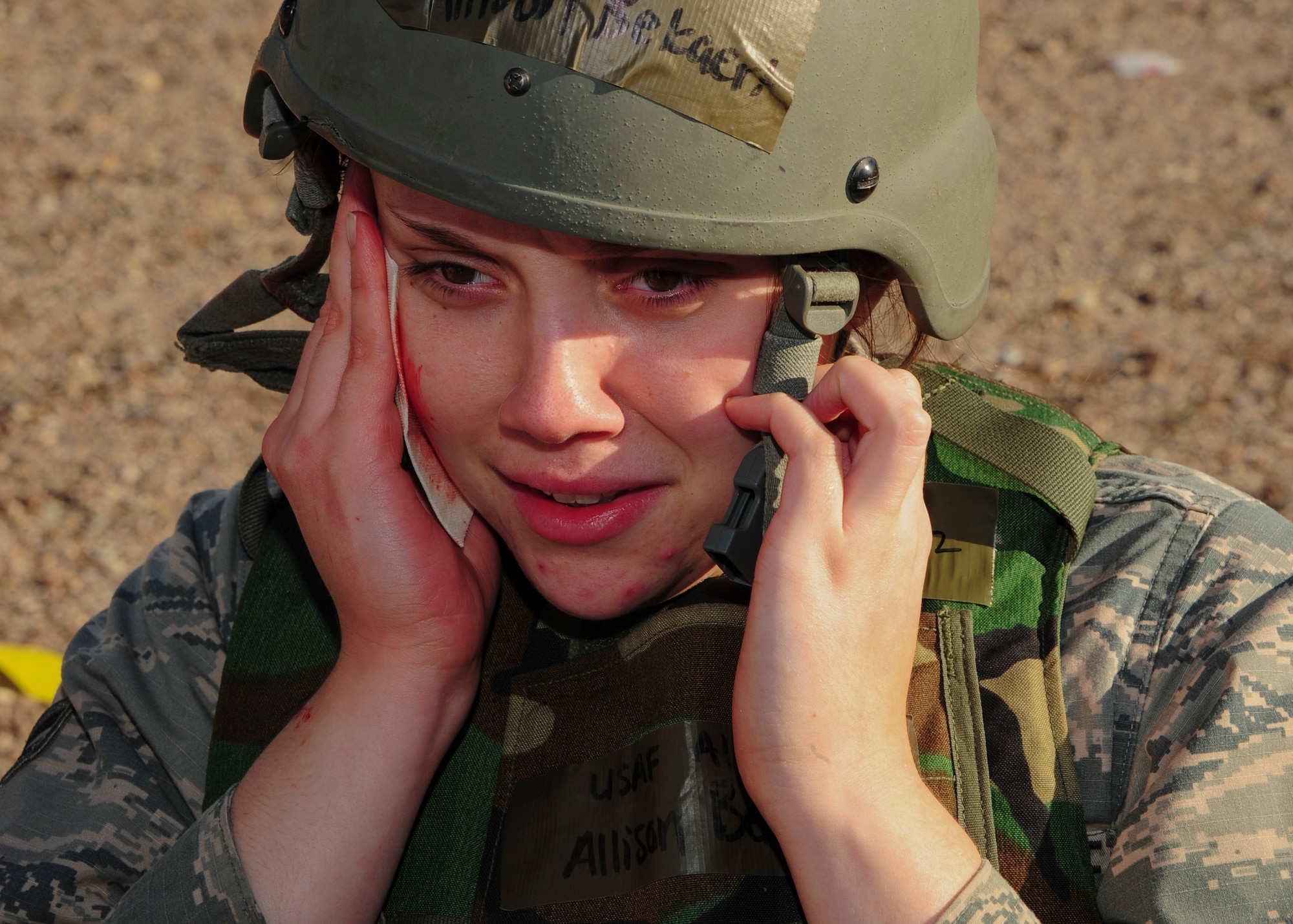 U.S. Air Force Airman 1st Class Allison Bekaert, 355th Force Support Squadron food services apprentice, acts as a simulated trauma patient during Exercise BUSHWHACKER 15-07 at Davis-Monthan Air Force Base, Ariz., Nov. 5, 2015. During the exercise, Bekaert and other Airmen acted as patients and used moulage to create a realistic experience, allowing medical Airmen to perceive the wounds they were treating. (U.S. Air Force photo by Airman Basic Nathan H. Barbour/Released)